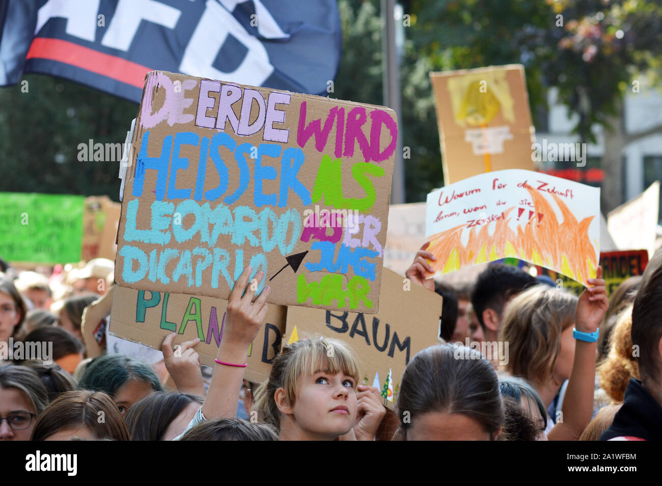 Protest sign saying `Earth is getting hotter than Leonardo DiCaprio when he was young` held up by young people during Fridays for Future Stock Photo